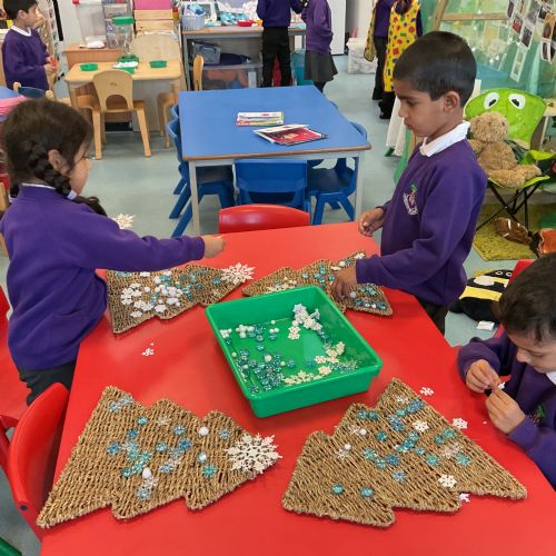Snowflake painting, decorating trees, playdough and snowscape collages.