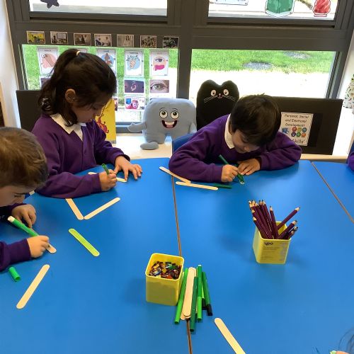 Christmas Art Week - We made festive Christmas trees using lolly sticks and sequins!